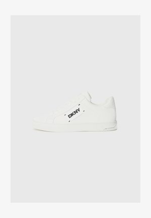White leather sneakers featuring a flat sole, rounded toe, and a black DKNY logo on the side. Smooth texture with minimal detailing.