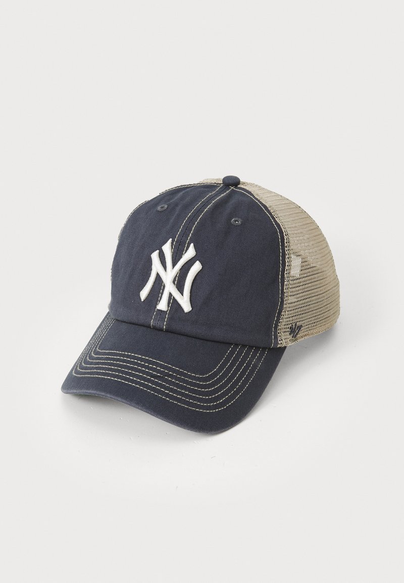 Gorra azul marino con visera curva, que presenta un logo blanco en la parte frontal y una malla beige en la parte posterior. Material de algodón con detalles bordados.
