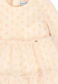 Vestido para bebé de color crema con mangas largas y pequeño patrón de mariposas, que presenta una falda con volantes de tul y una etiqueta que dice "mayoral".