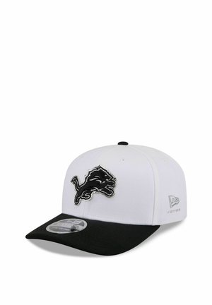 White and black baseball cap with a black lion logo on the front and New Era brand mark on the side.