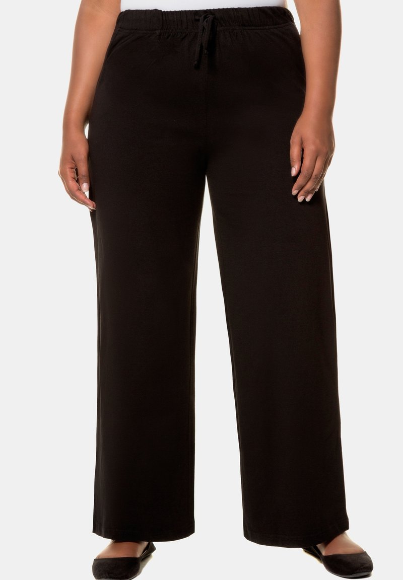 Schwarze, weit geschnittene Hosen aus weichem Material, mit einem elastischen Bund und einer Kordel. Glatte Textur und lässiges Design.