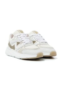 Beige and white mesh sneakers with flat laces, padded collar, and textured accents; rubber sole with subtle tread pattern.