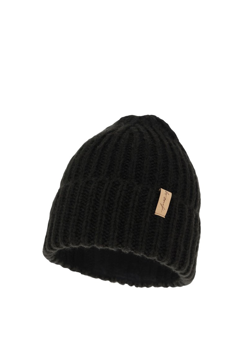Black knitted beanie with ribbed texture, featuring a small tan label on the side. The design is fitted, tapering towards the top.