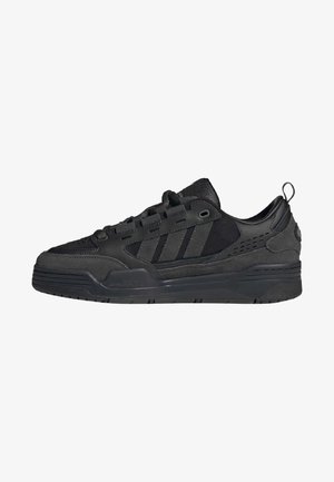 Czarny niski sneaker z panelami z zamszu i skóry, sznurowanie z przodu, trzy paski po boku oraz pętelka na pięcie.