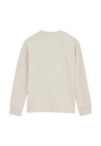 Gaiši beiga garām piedurknēm brīvā laika krekls ar apaļu kakla izgriezumu, ribota tekstūra un aproces. Aizmugurē ir vienkāršs dizains bez jebkādiem logo vai rakstiem.