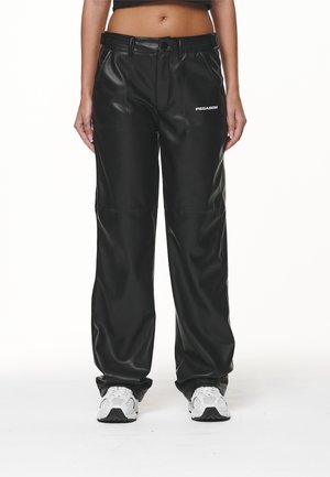 Black faux leather pants with a relaxed fit, featuring a belt and visible stitching. Logo "PEGADOR" on the front. Smooth texture.