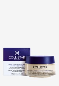 Collistar Milano anti-rynke dagcreme i et klart glasglas med et marineblå låg, ledsaget af en lilla kasse med hvid tekst.