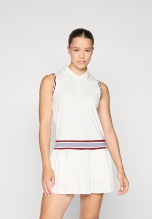 White sleeveless dress with a collared neckline, pleated skirt, and a horizontal striped waistband in navy and burgundy. Features logo detail.