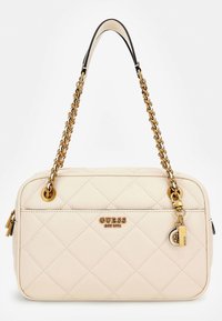 Beige laukku, jossa on tikattu pinta, kultaketjushokki, vetoketjukiinnitys ja kultalogomerkki. Sisältää pienen lukon koristeen. Liukas pinta.