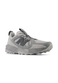Chaussure de sport gris clair en matériaux mesh et daim, semelle en caoutchouc texturé, col rembourré et lacets élastiques. Détails de design angulaires tout au long.
