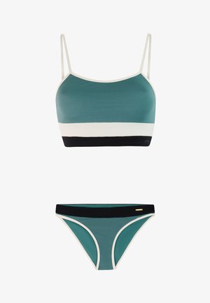 Tweedelig badpak met kleurvlakken in turquoise, wit en zwart, voorzien van dunne bandjes op het bovenstuk en contrasterende afwerking op beide delen.