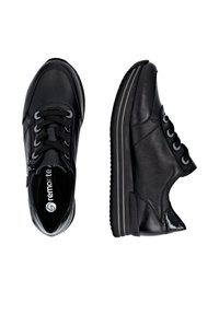 Black sneakers with a smooth leather upper, textured accents, a lace-up design, and contrasting stripes on a thick sole.