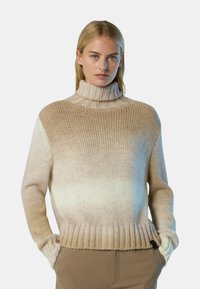 Chunky Strick-Turtleneck-Pullover in einem abgestuften Beigeton, mit geripptem Saum und Bündchen. Strukturiertes Gewebe mit lockerer Passform und seitlichen Taschen.