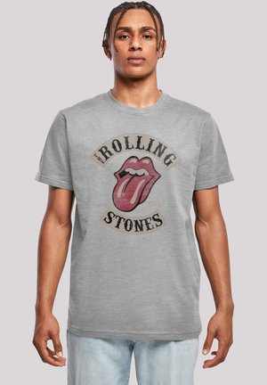 Gray cotton t-shirt featuring a prominent red lips and tongue graphic with "ROLLING STONES" text. Short sleeves and round neckline.