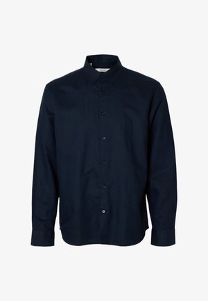 Sötét tengerészkék, hosszú ujjú, gombos ing hegyes gallérral és gombos mandzsettával, fehér háttéren bemutatva.