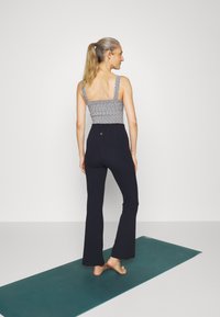 Athleta ELATION FLARE PANT - Leggings - navy