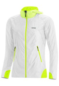 Chaqueta ligera blanca con acentos en amarillo neón, con cierre de cremallera, dos bolsillos laterales y capucha. Tejido texturizado para mayor transpirabilidad.