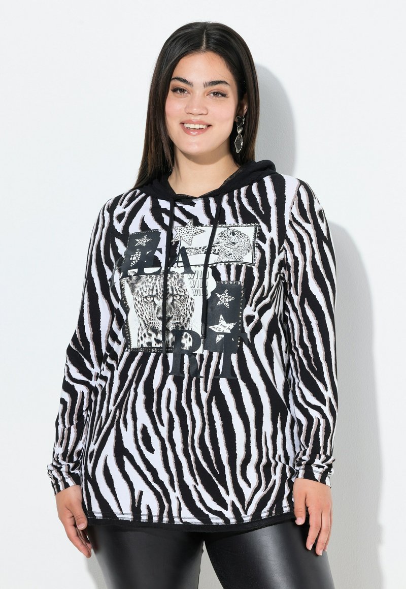 Schwarz-weiße, zebra gestreifte Kapuzenjacke mit einem Frontdesign, das Leopard-Bilder und Sterne zeigt. Lange Ärmel, mit Kordelzug, gerippte Bündchen.