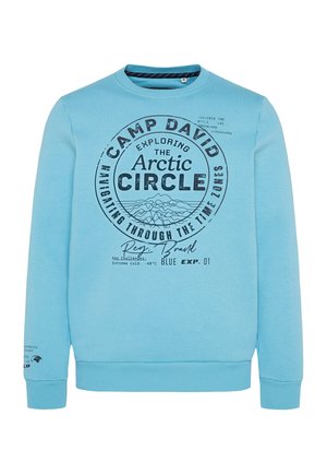 Hellblauer Sweatshirt mit Rundhalsausschnitt, ausgestattet mit einem großen, runden Grafikdruck, der Texte und Bergillustrationen zeigt. Gerippte Bündchen und Saum.