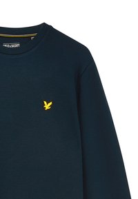 Marinblå sweatshirt tillverkad av mjukt material, med rund halsringning och en liten gul broderad fågel-logotyp på bröstet.