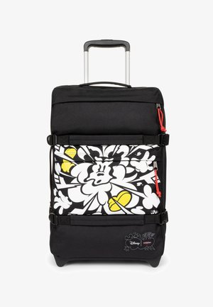 Valise à roulettes noire avec poignée rétractable, avec un motif cartoon blanc et jaune et des tirettes de fermeture éclair rouges.
