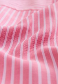 Light pink fabric with white vertical stripes; smooth texture; closely woven material, creating a subtle sheen.