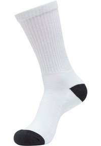 Weiße, gerippte Socke mit schwarzem Zeh und Ferse, aus einem weichen Stoff gefertigt, der eine nahtlose Konstruktion für Komfort und Langlebigkeit aufweist.