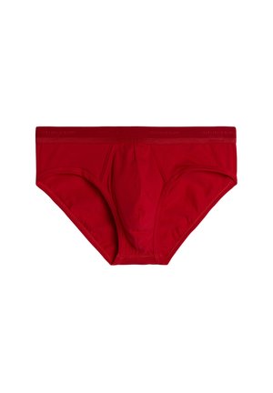 Červené bavlněné slipy s těsným střihem, které mají středně vysoký pás a přední kapsu. Hladká textura s minimem švů.