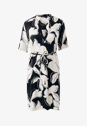 Vestito a maniche corte con motivo floreale in bianco e nero, scollo a V e vita con coulisse. Tessuto liscio con una vestibilità comoda.