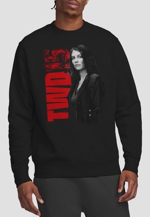 Black sweatshirt with a grayscale woman wearing a jacket and backpack, next to large distressed red text reading "TUNNEL."