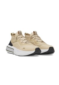 Beige athletic sneakers with knitted upper, textured detailing, tonal laces, reinforced heel, and contrasting black and white sole accents.