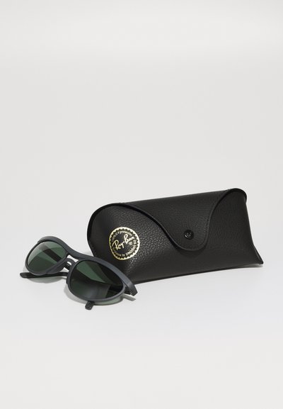 Lunettes de soleil Ray-Ban avec des verres vert foncé, une monture en plastique noir et un étui en cuir noir texturé avec un logo doré.