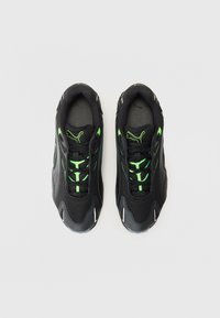 Black athletic shoes with mesh and synthetic material, featuring neon green accents and laces, a rounded toe, and textured rubber sole.
