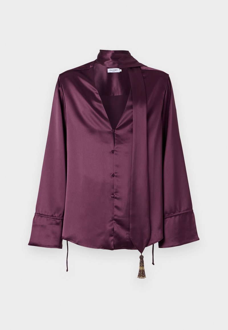 Satin blouse in deep burgundy, featuring a v-neck, long sleeves, button front, and a tie detail with a decorative tassel at the hem.