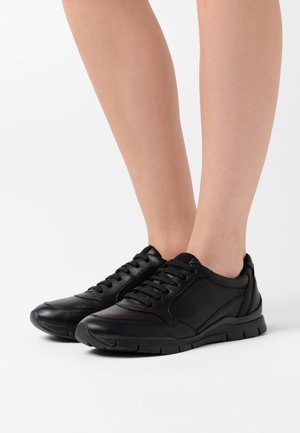 Sneakers neri in pelle con superficie liscia, punta rotonda e design con lacci. Presentano una suola imbottita e sottili dettagli laterali.