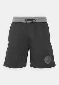 Black athletic shorts with a gray elastic waistband and drawstring. Features a round patch with "PARIS" in a raised design. Smooth texture.