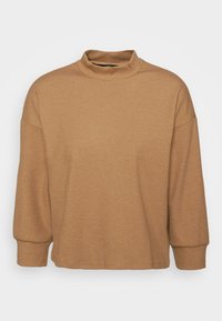 Brauner, gestrickter Pullover mit hohem Stehkragen, relaxter Passform und überschnittenen Schultern. Besitzt eine strukturierte Oberfläche und lange Ärmel. Keine sichtbaren Muster.