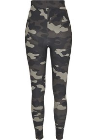 Leggings camouflage dans des nuances de noir, gris et vert olive, dotés d'une taille haute et d'un matériau lisse et extensible.