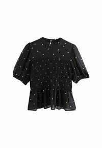 Svart blus med puffärmar, med en smockad midja och vita prickar, avslutad med en volangkant och nyckelhålsstängning bak.