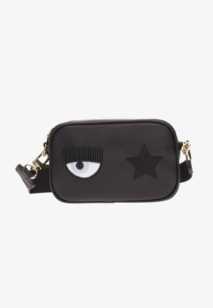 Bolso bandolera rectangular negro con un ojo único y pestañas largas bordadas a la izquierda y una estrella negra a la derecha, con cierres dorados.
