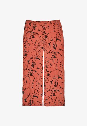 Hochtaillierte gerade Hosen in Terrakottafarbe mit einem unregelmäßigen schwarzen Punktmuster.