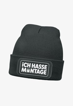 Schwarze gestrickte Mütze mit umgeschlagenem Bündchen, die einen rechteckigen Aufnäher mit dem Aufdruck "Ich hasse Montage" in weißer Schrift und einem Cartoon-Charakter zeigt.
