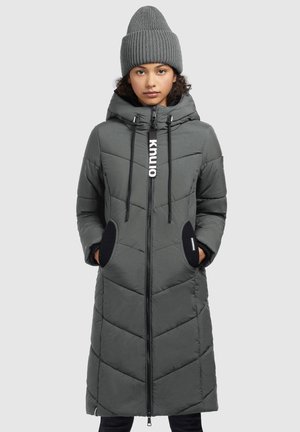 Gray padded long coat with a zip front, hood, and chevron pattern. Features side pockets with black accents. Worn with a matching knit beanie.