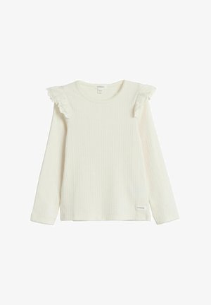 Geripptes, langärmliges cremefarbenes Oberteil mit dezenten Rüschendetails an den Schultern und Spitzenbesatz an den Manschetten; Etikett unten links sichtbar.