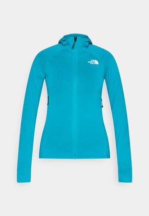 Jopica s turkiznim zadrgo, s prileganim krojem, dolgimi rokavi in kapuco. Ima majhen logotip na prsih in teksturirano tkanino.