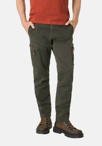 Cargo pants in dark green cotton blend, featuring multiple side pockets, a tapered fit, textured finish, and a simple waistband design.