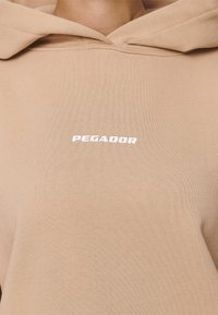 Pegador Jersey con capucha - sand