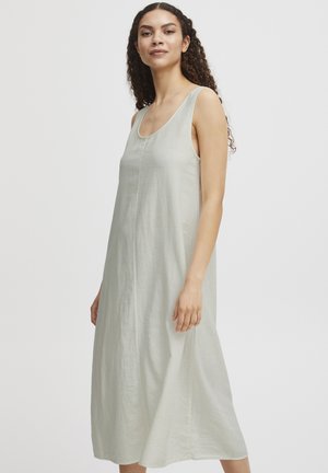 Light gray sleeveless dress made of textured fabric, featuring a rounded neckline and a loose, flowing design that falls below the knee.