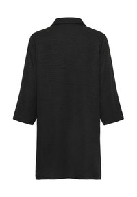 Chemise noire texturée à manches longues avec col, vue de dos sur un fond blanc.