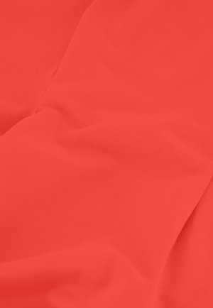 Close-up of smooth, bright red fabric with subtle folds and soft texture.